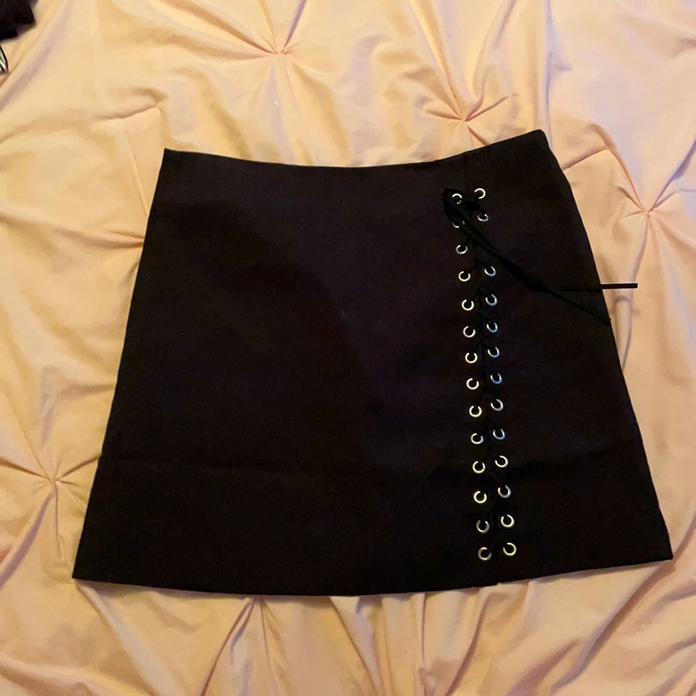 Black lace up decor skirt with zipper in the back.